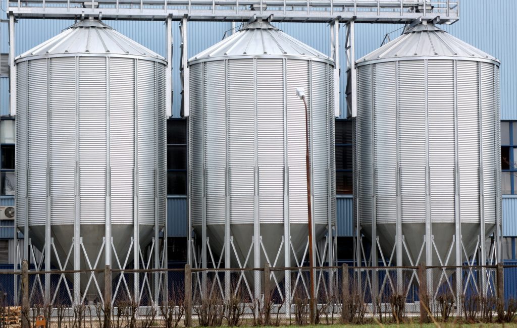 Three shiny steel storage tanks